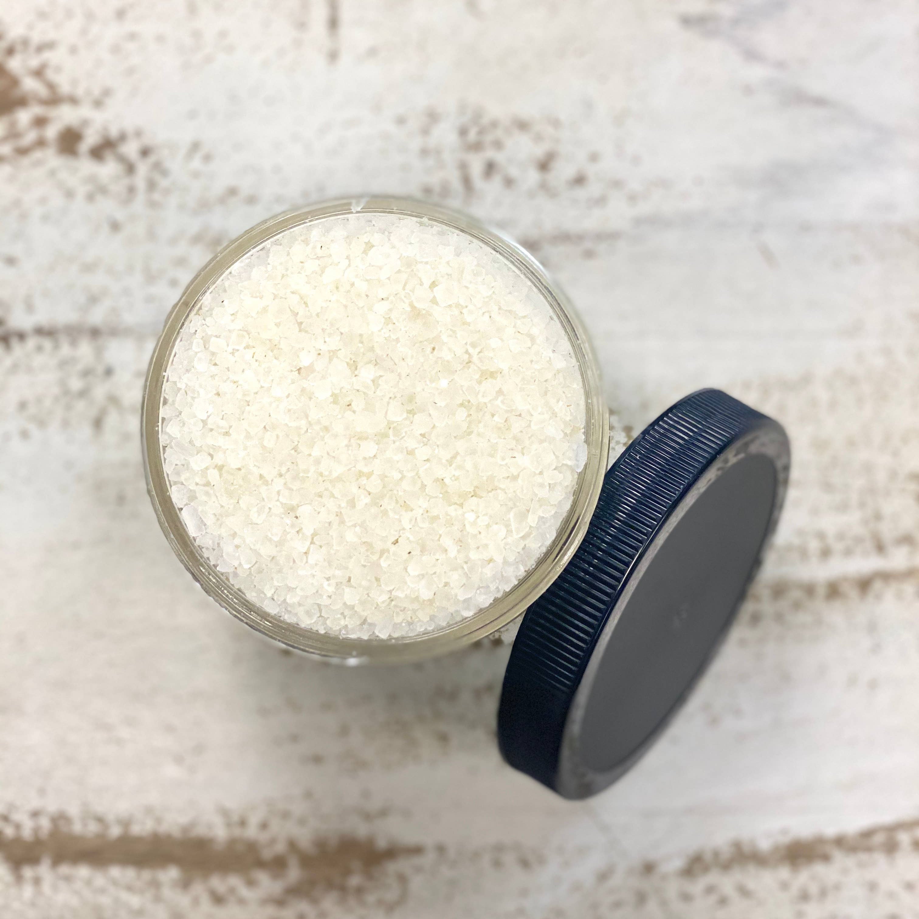 open jar of salt for body scrubbing