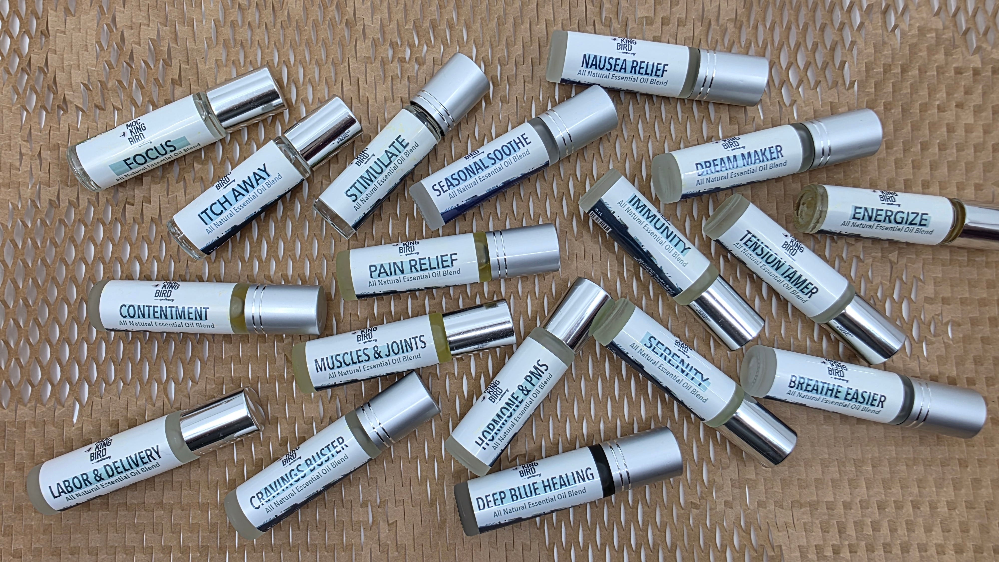 Various small bottles labeled with different remedies on a textured surface