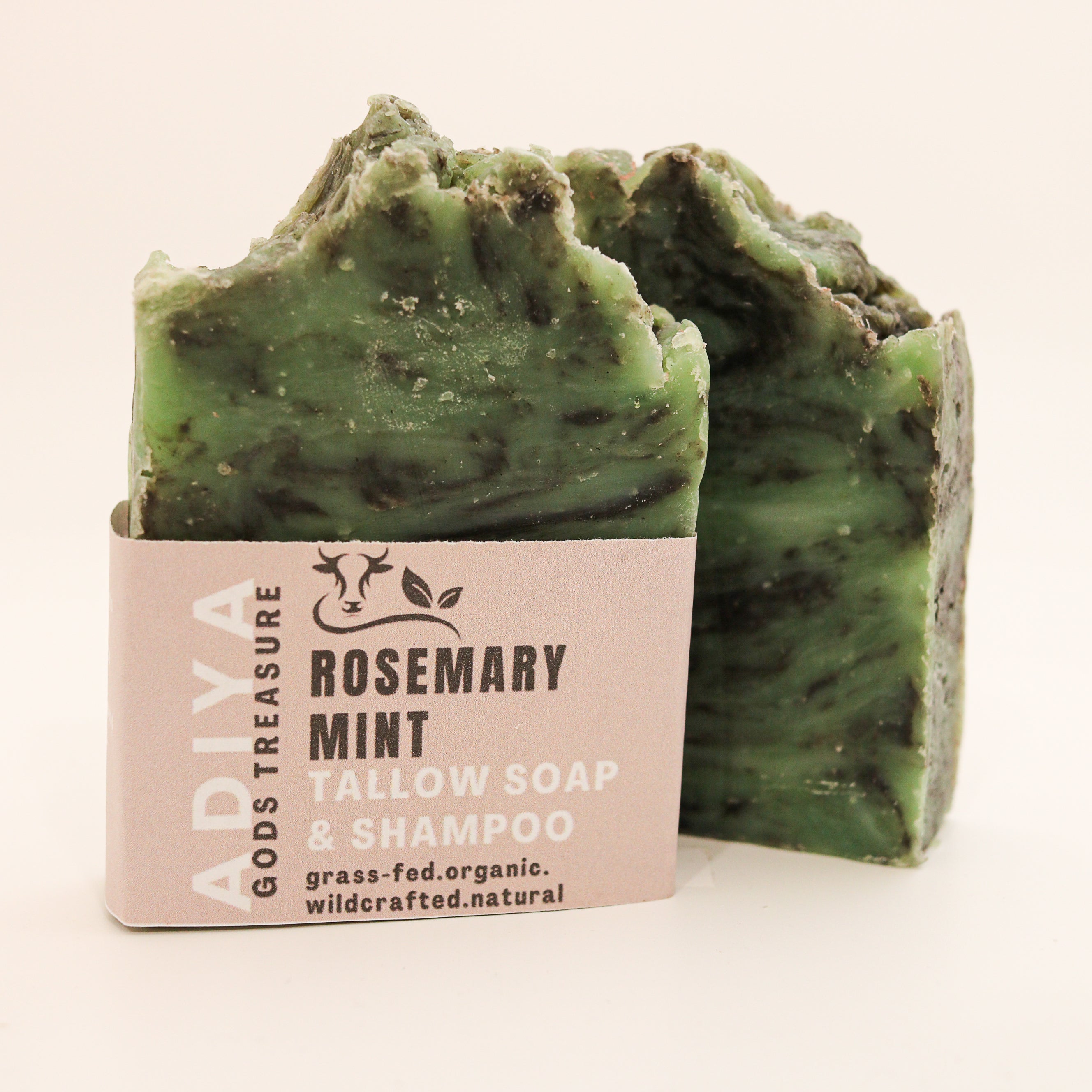 'Rosemary Mint' labeled green soap bar with a pink label on a white background