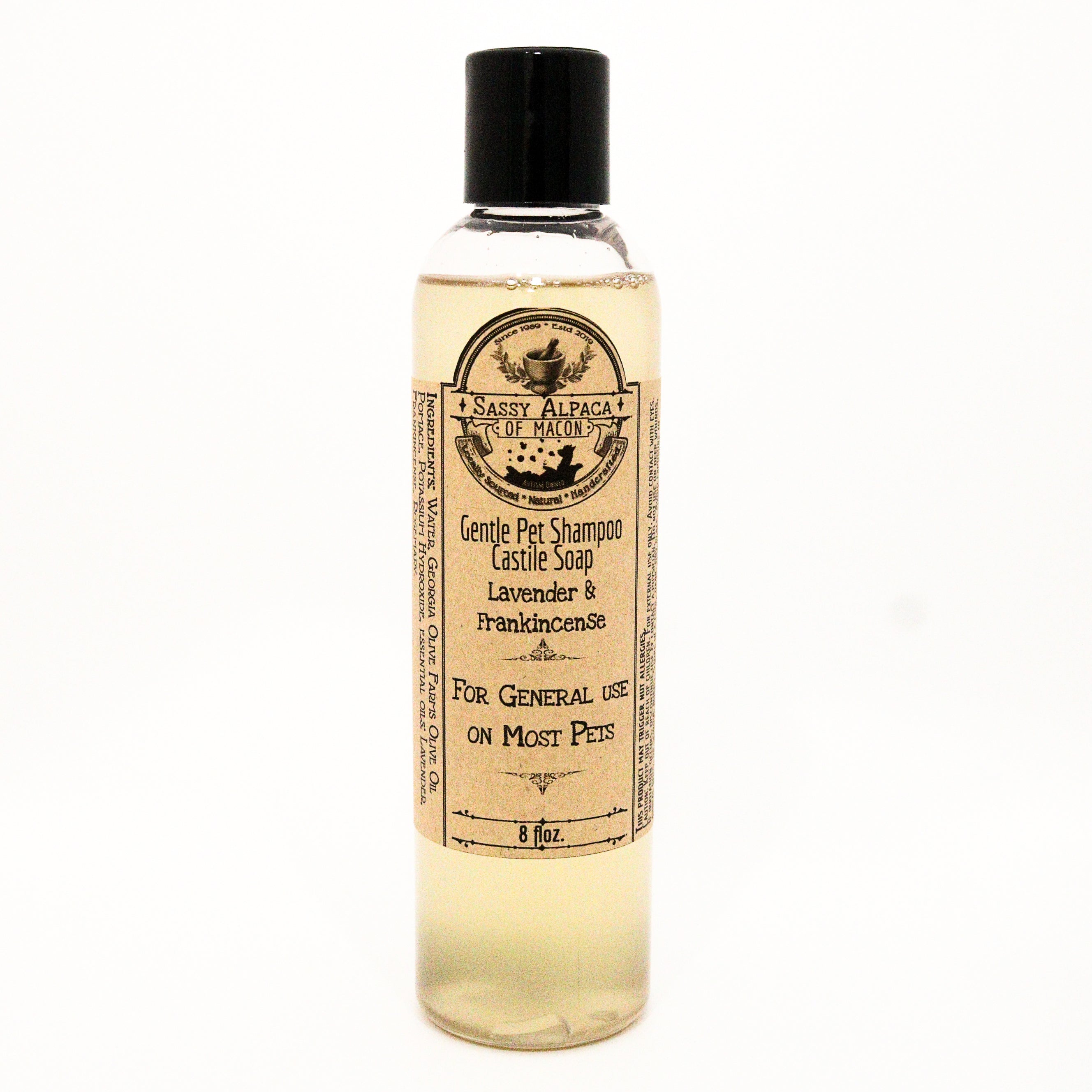 clear bottle with yellow liquid inside gold label with gentle pet shampoo castile soap  lavender and frankincense