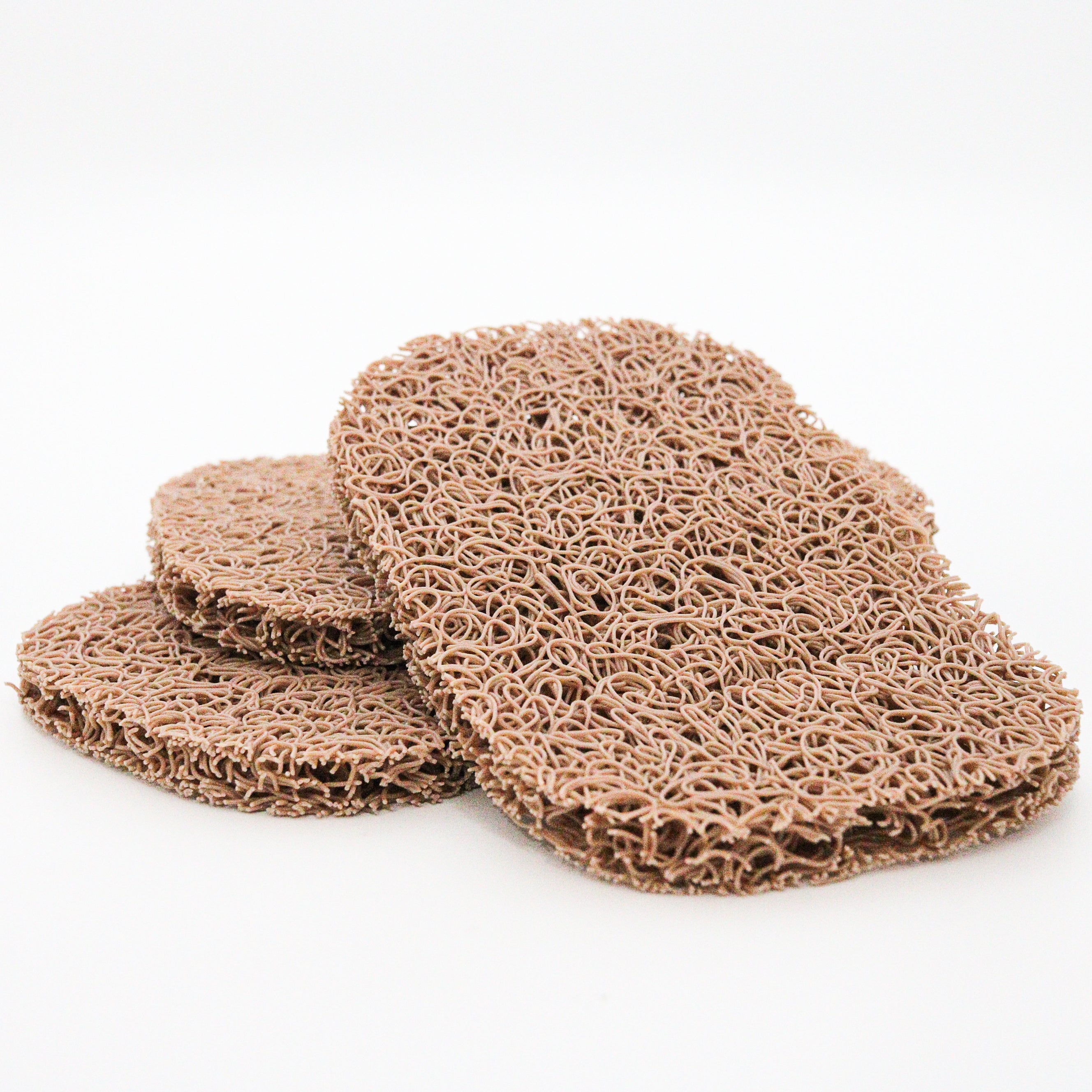 Three brown soap lift pads on a white background