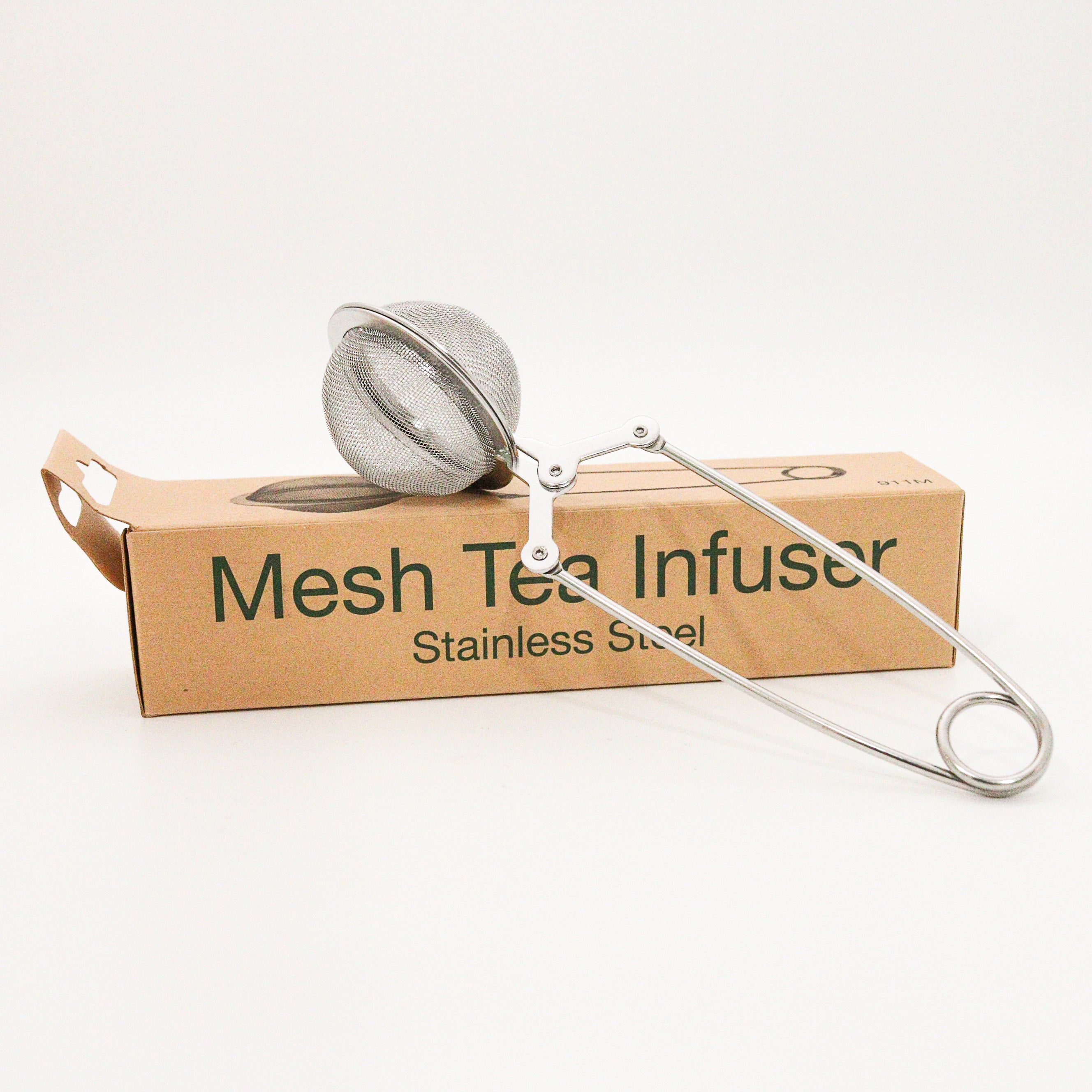 Stainless steel mesh tea infuser on a cardboard box with text