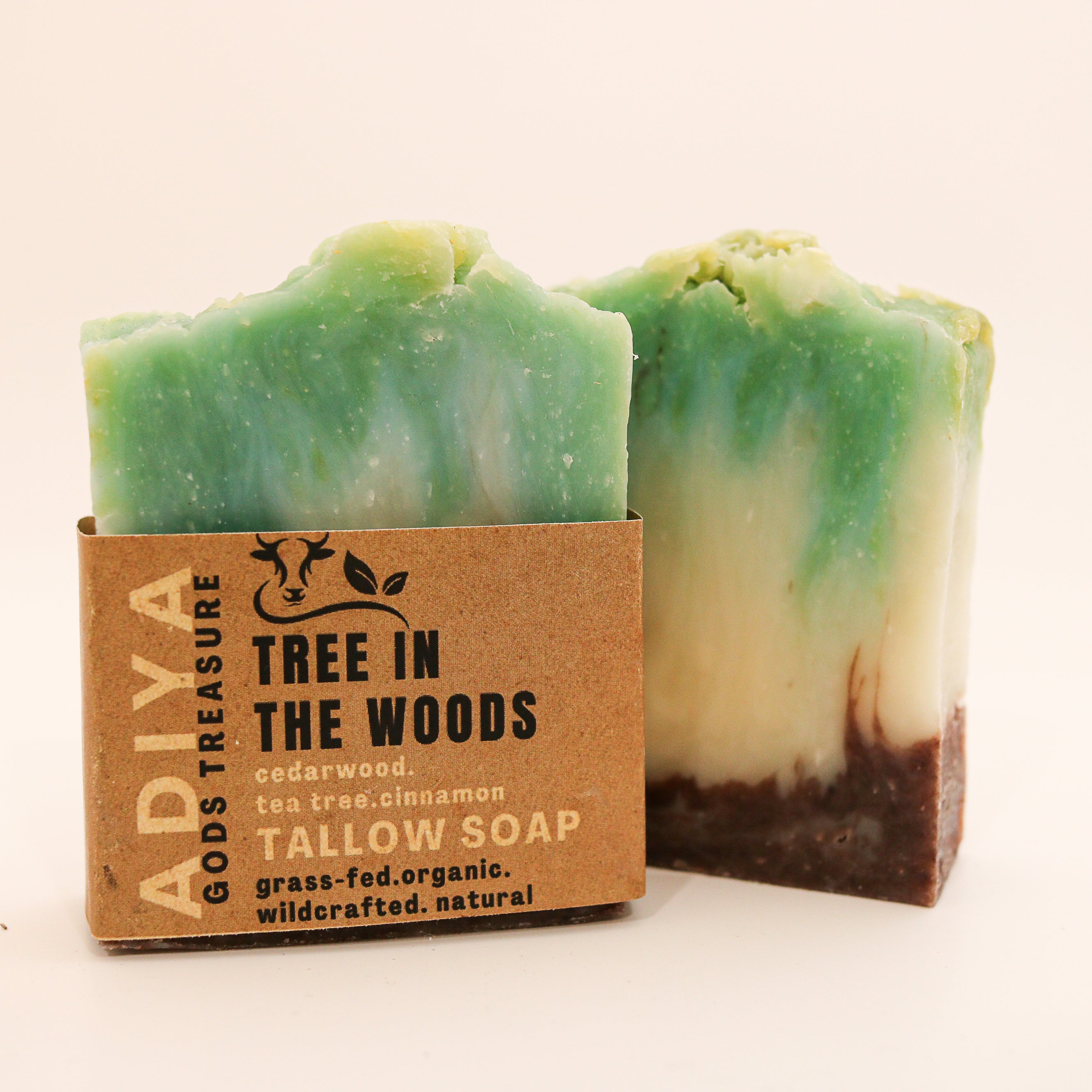 Two bars of soap with a cardboard box labeled 'Tree in the Woods' on a white background