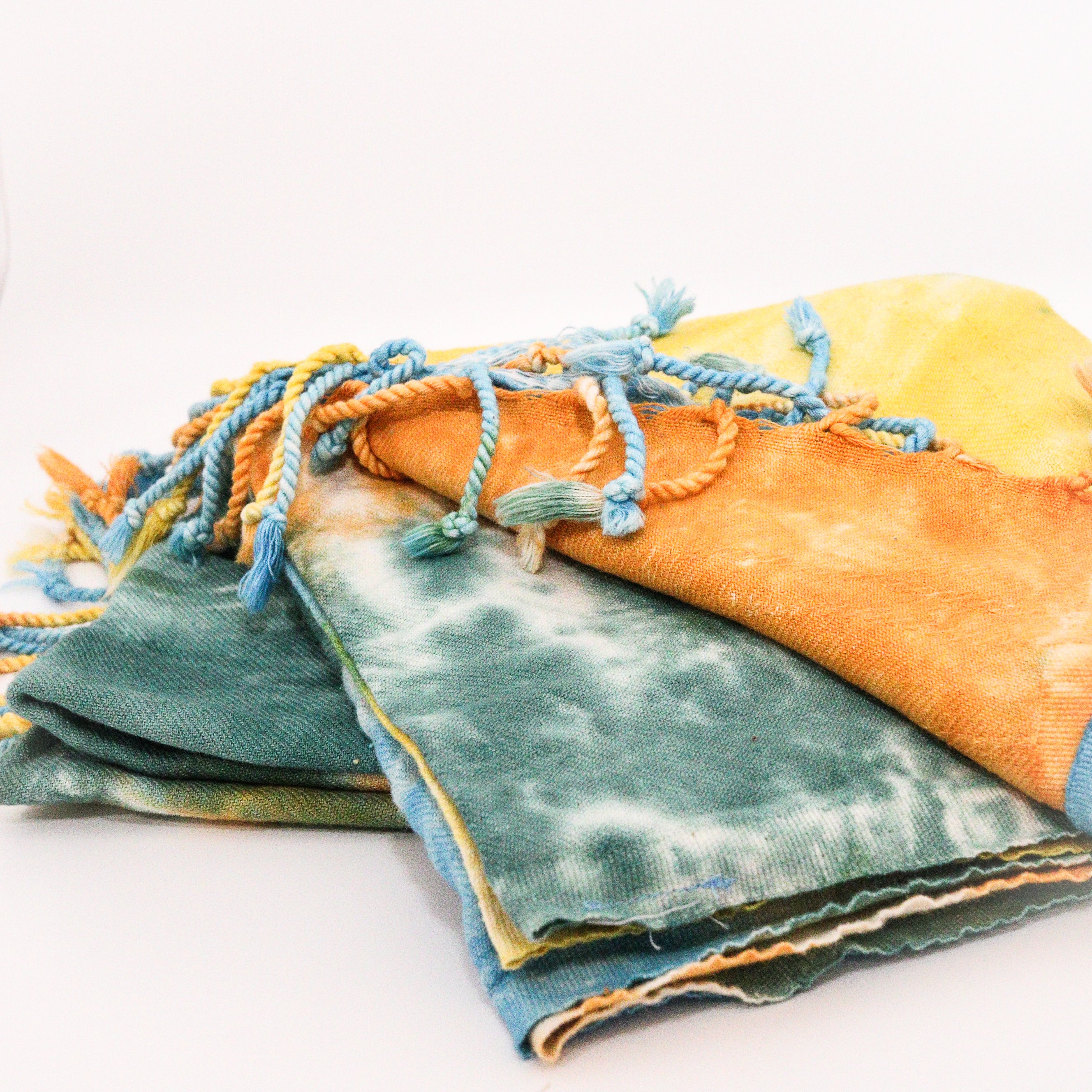 Turkish Towel tie-dye organic cotton in green, orange, and blue on a white background