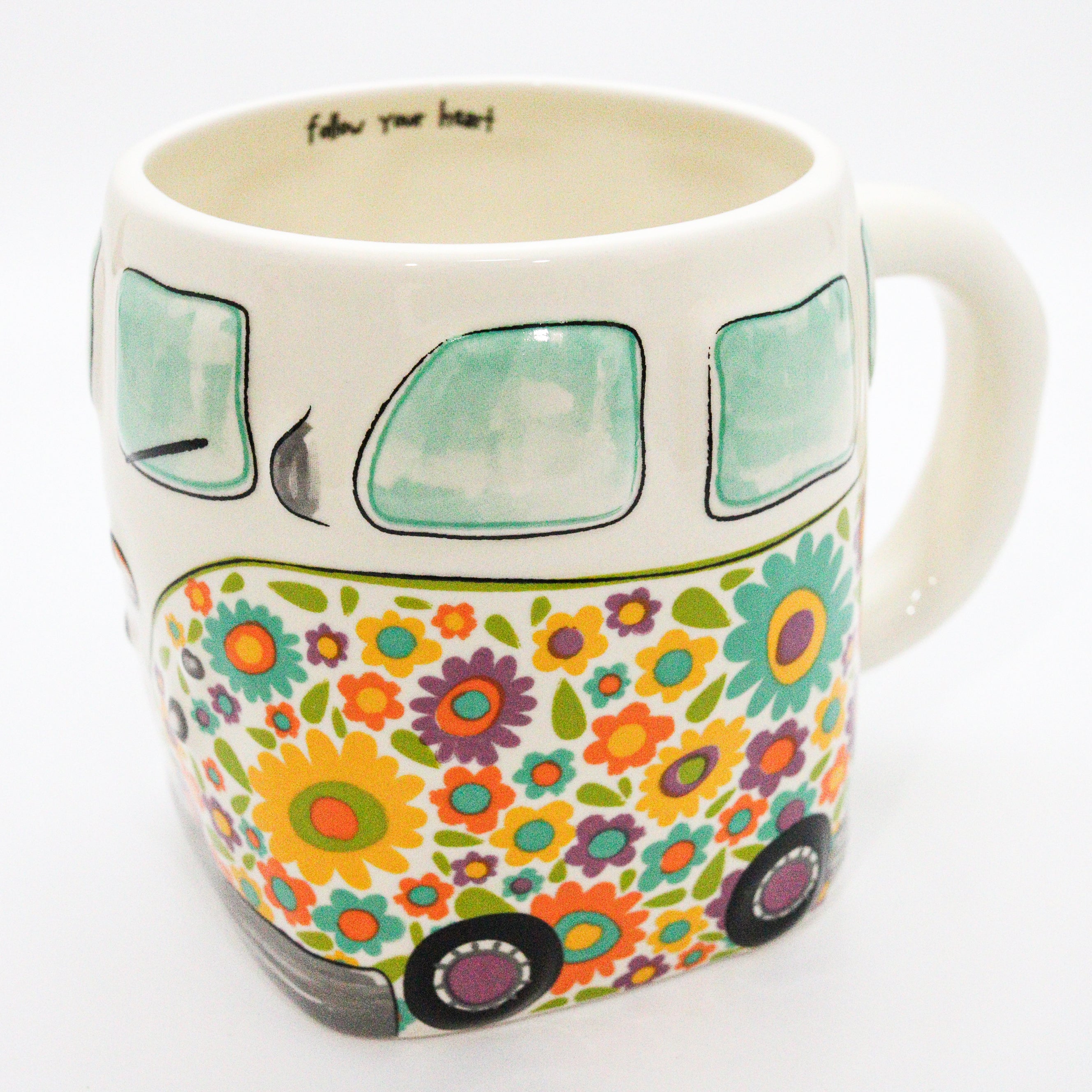 Mug with floral design and text 'follow your heart' on a white background