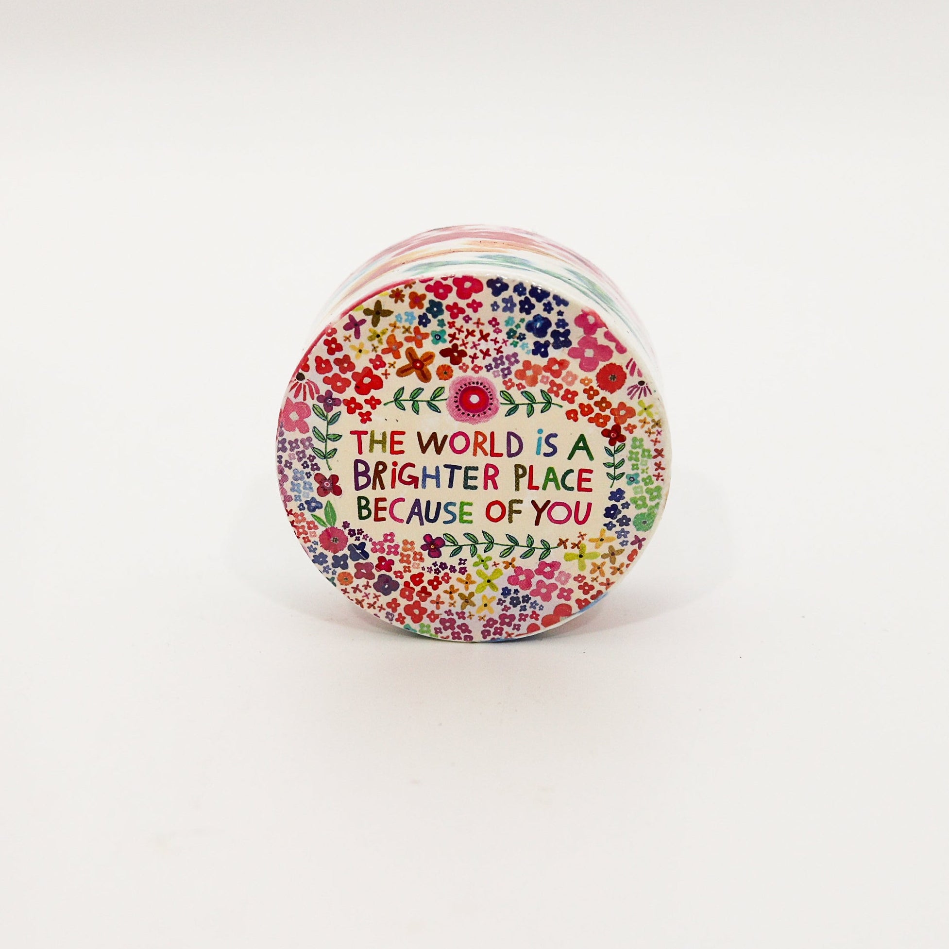 small container with floral design and motivational quote on a white background