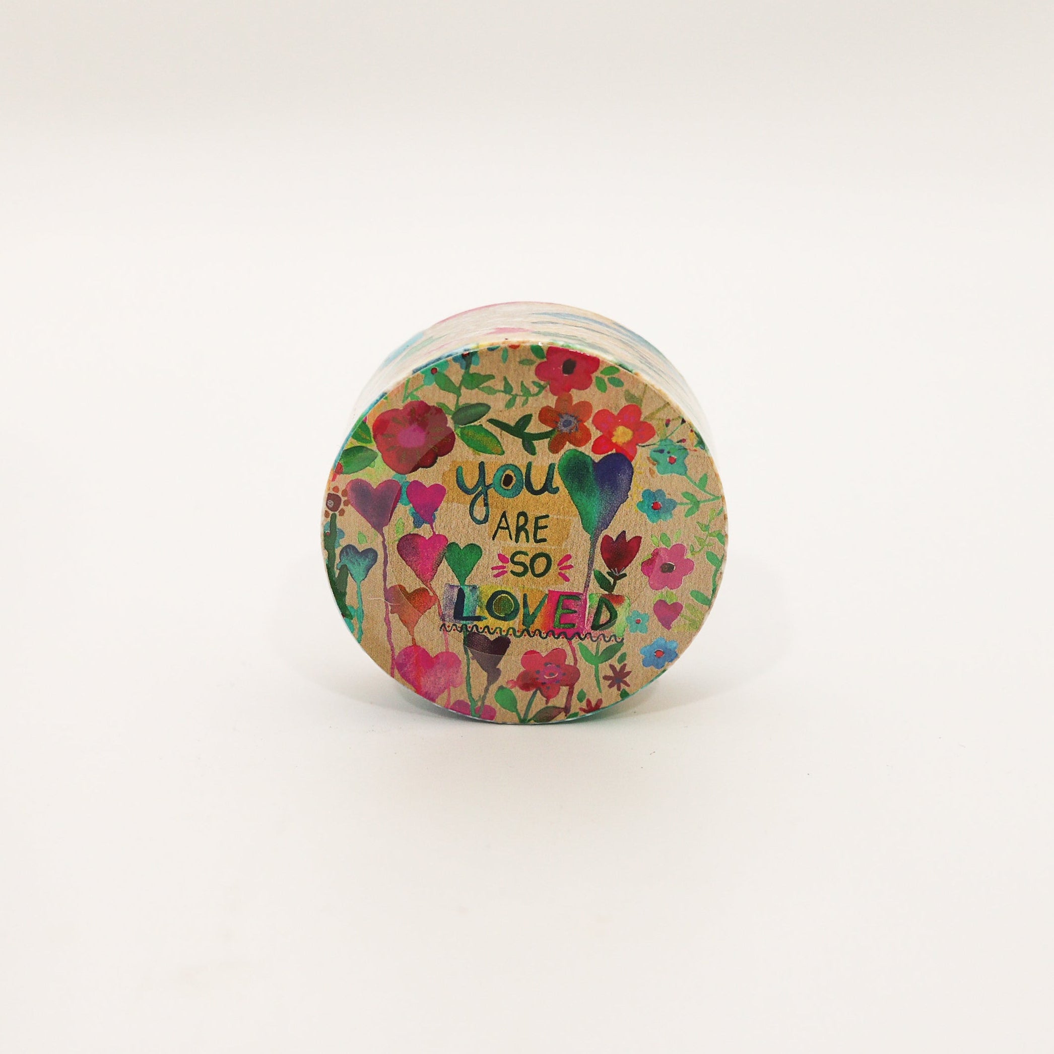 Small container with floral design and text on a white background