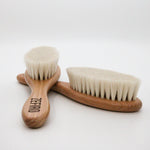 Two wooden baby fine hair brushes with natural bristles on a white background