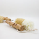 Two wooden bottle cleaning brushes with bristle heads on a white background, branded 'Zefiro'.