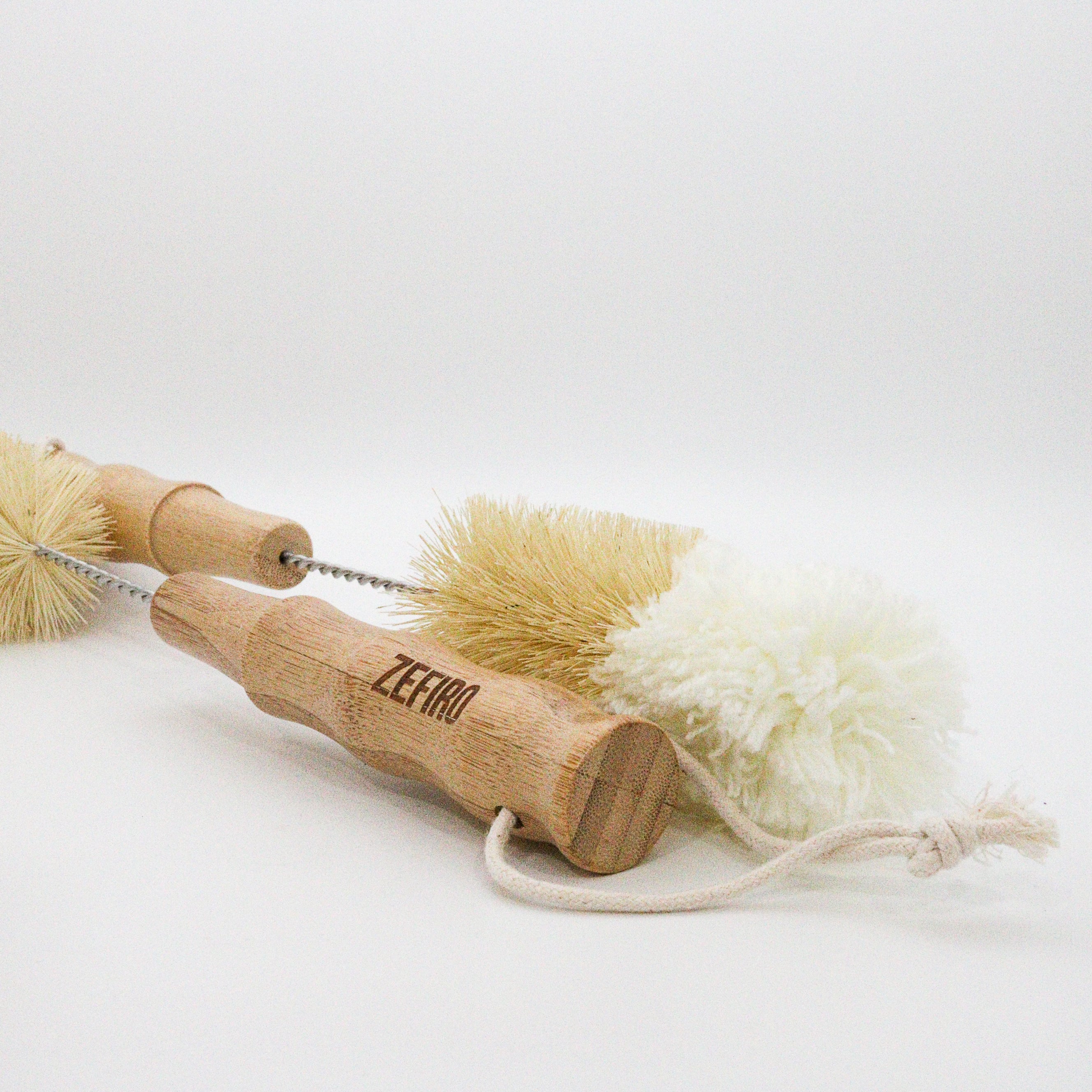 Two wooden bottle cleaning brushes with bristle heads on a white background, branded 'Zefiro'.